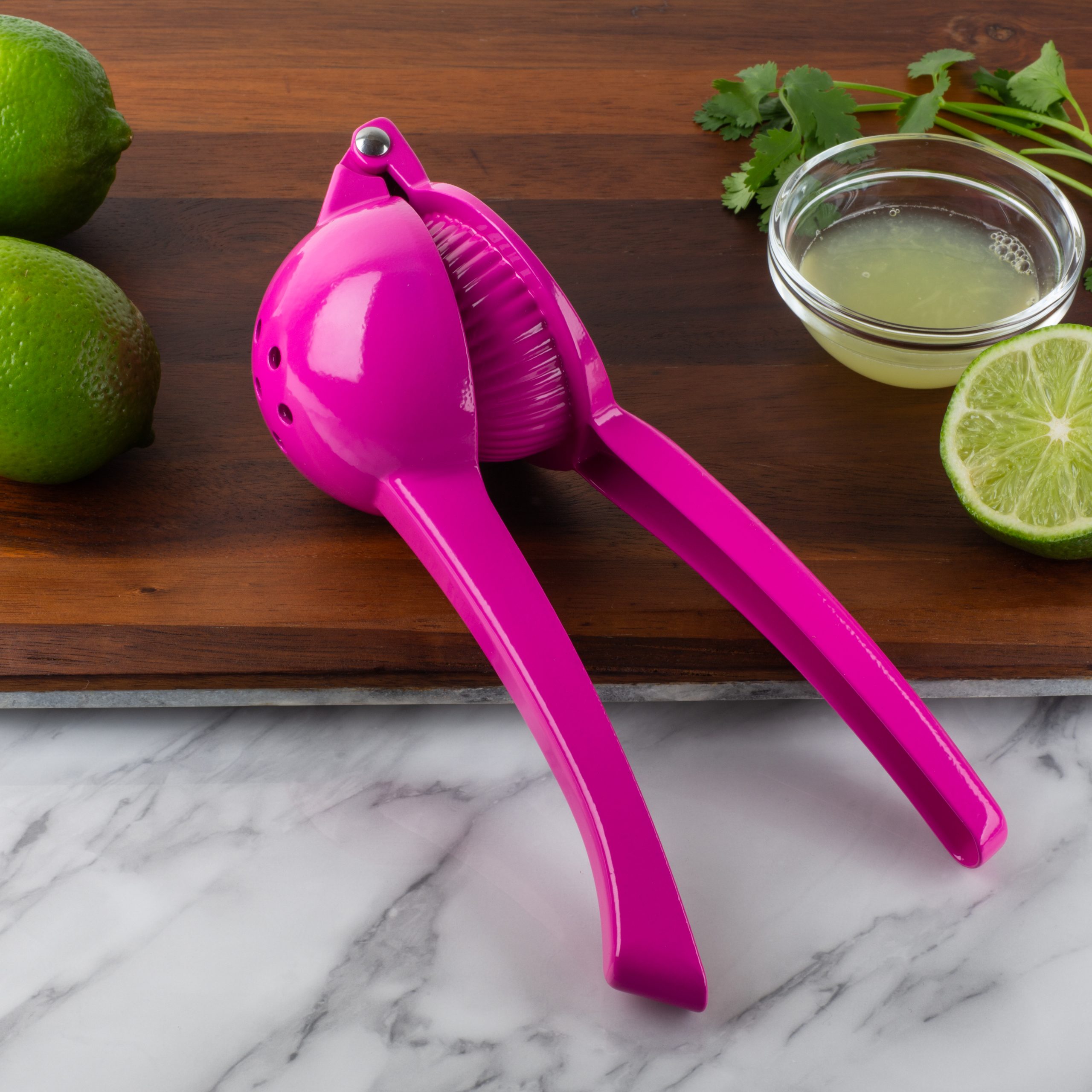 Pink Lemon Juicer on wood cutting board